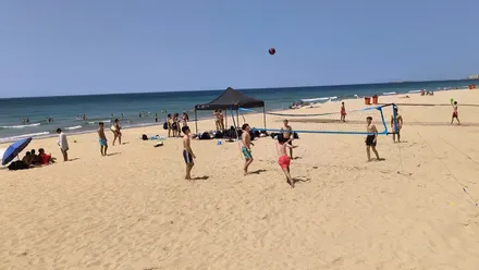 Un grupo de jóvenes juegan al futvoley en la Playa de la Victoria de Cádiz.