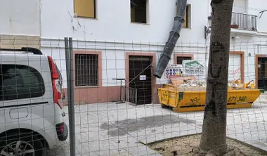 Una cuba en la puerta de acceso al albergue municipal de Cádiz durante las obras de reforma. La zona está vallada