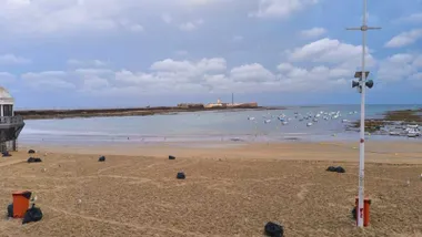 Playa de la Caleta con nubes al amanecer