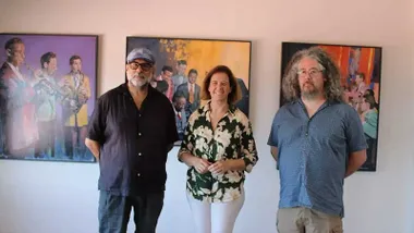 Manuela Pérez junto a Benítez posando delante de unos cuadros de la exposición "Otras músicas".