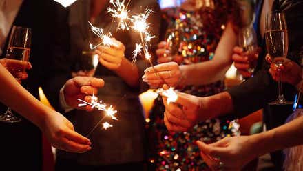 Varias personas lucen las títpicas bengalas de fin de año.