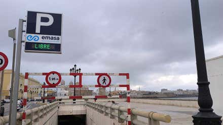 Vista de una de las entradas al aparcamiento del Campo del Sur, en Cádiz. Se observan señales de deterioro en la estructura y ausencia de actividad de obras. Al fondo se distingue el Paseo del Campo del Sur y la Catedral de Cádiz.