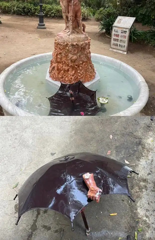 La escultura sin los brzos ni el paraguas. Brazo roto y paraguas de la escultura dentro del agua de la fuente del Parque Genovés.