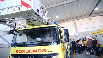 Camión de bomberos de Cádiz, amarillo y rojo y un grupo de personas tras el mismo.