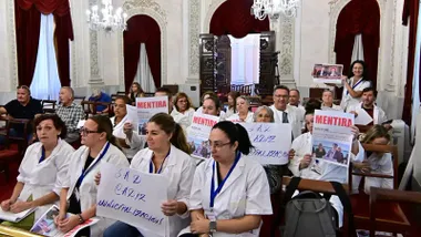 Trabajadoras del Servicio de Ayuda a Domicilio en el Pleno de septiembre del ayuntamiento de Cñadiz con pancartas que acusan de mentiroso al alcalde.