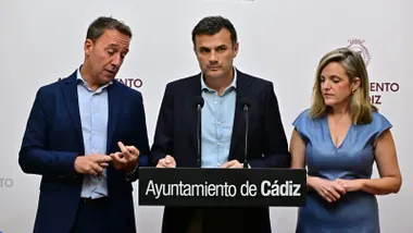 El alcalde Bruno García en el atril durante una rueda de prensa, con José Manuel Cossi a su derecha que está explicando algo y Mayte González a su izquierda, en la sala de prensa del Ayuntamiento de Cádiz.