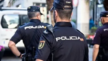 Grupo de tres policías nacionales en una calle.