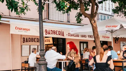 Imagen de la terraza de la nueva Taberna la Barberia, con varias personas sentadas en las sillas compartiendo algunas bebidas
