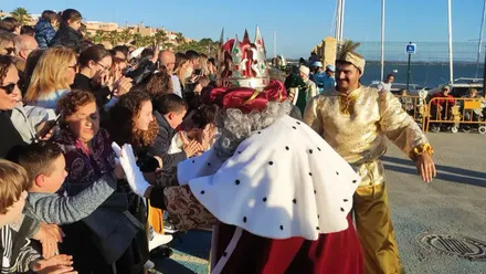 Rey Mago junto a un paje saludando a las personas.
