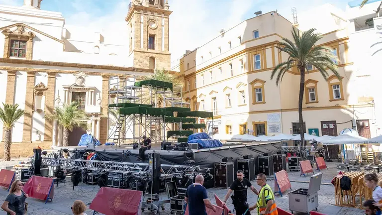 Operarios montan el escenario para la obra 'Babell' mientras dos personas observan los trabajos.