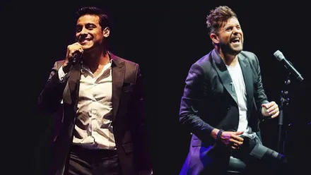 Los cantantes Carlos Rivera y Pablo López en un fondo negro.