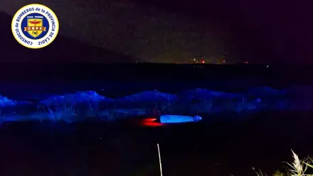 Techo de un automóvil que sobresale, junto con las luces rojas, del agua del canal.