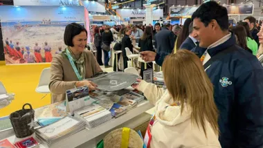 Mujer explicando a dos personas temas de Rota y sus excelencias.