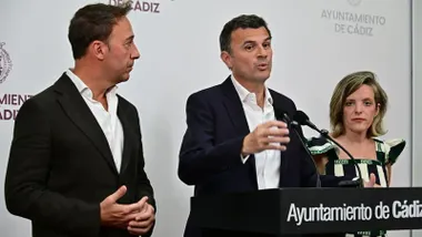 Bruno García comparece ante los medios en la sala de prensa del Ayuntamiento de Cádiz tras la Junta de Gobierno Local. El alcalde está sentado en el centro de la mesa y habla durante su intervención, acompañado por la primera teniente de alcalde, Maite González, a su izquierda, y el segundo teniente de alcalde, José Manuel Cossi, a su derecha.