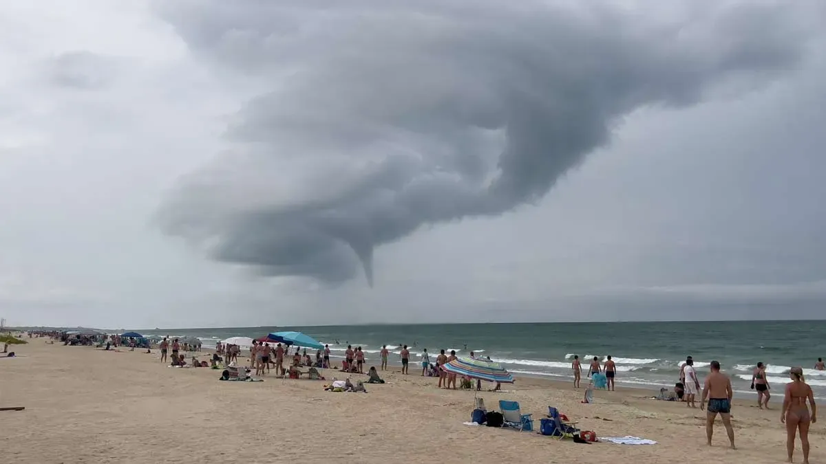 Formación de una manga marina en la costa de Cádiz, se ve el cono de vientos en el cielo.