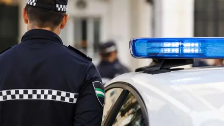 Policía Local junto a su automóvil.