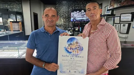 Cartel de la Noche en Blanco de Crevillet sostenido por el delegado y el organizador.