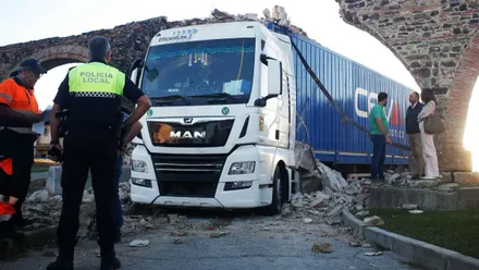 Camión y el arco dañado en Algeciras, hay agentes de la Policía Local y el conductor.